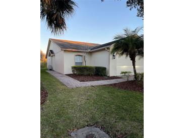 Charming home featuring manicured landscaping, a brick walkway, and a well-maintained lawn at 536 Grand Canal Dr, Kissimmee, FL 34759