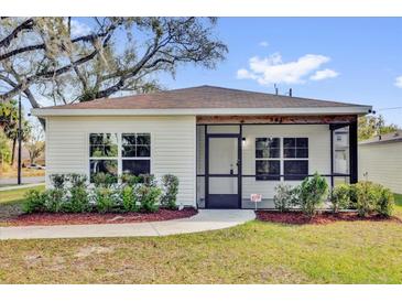 Charming single-story home featuring a cozy porch and well-maintained landscaping at 901 S Holly Ave, Sanford, FL 32771