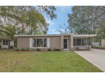 Charming single-story home with a well-maintained lawn and inviting front porch at 119 Mayfair Cir, Sanford, FL 32771