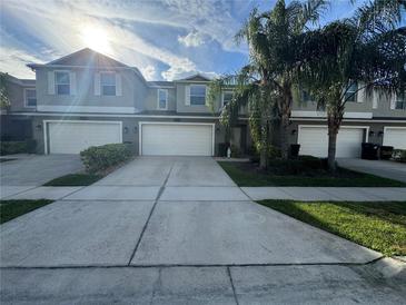 Inviting townhome with well-maintained landscaping and a large driveway at 15198 Harrington Cove Dr, Orlando, FL 32824