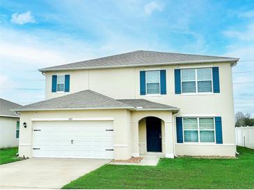 Charming two-story home featuring a well-manicured lawn and inviting front entrance at 2837 Palatino Lane, Tavares, FL 32778