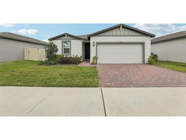 Charming one-story home featuring a brick driveway, well-maintained lawn, and inviting curb appeal at 3069 Cassidy Ln, Haines City, FL 33844