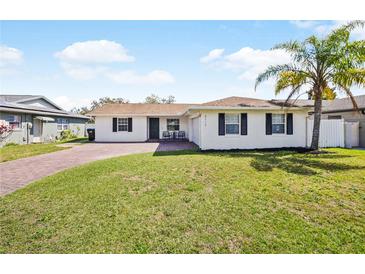 Charming single-story home with a well-maintained lawn, brick driveway, and a welcoming front porch at 3117 Shady Pine Ave, Winter Park, FL 32792