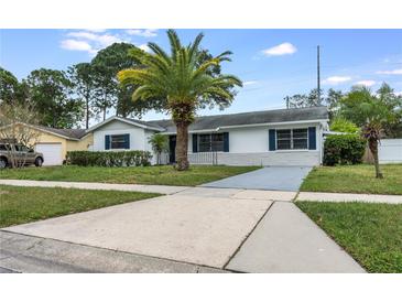 Charming one-story home with a well-maintained lawn and a palm tree in the front yard at 858 Darwin Dr, Altamonte Springs, FL 32701