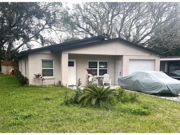 Charming single-story home with cozy outdoor seating and an attached garage at 1218 Depugh St, Altamonte Springs, FL 32701