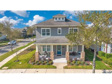 Charming two-story home with a welcoming front porch and landscaped yard at 13864 Sachs Ave, Orlando, FL 32827