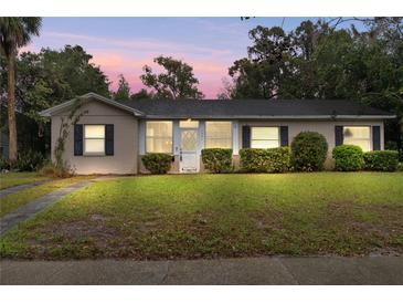 Charming single-story home with manicured lawn, black shutters, and a welcoming entrance at 1531 Norfolk Ave, Winter Park, FL 32789