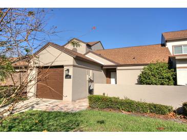 Charming home exterior featuring a one-car garage, manicured lawn, and a private entrance for added curb appeal at 2734 Cattail Ct, Longwood, FL 32779