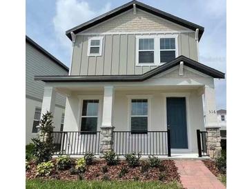 Charming two-story home with a welcoming front porch and well-maintained landscaping for excellent curb appeal at 316 South Zuni Rd, St Cloud, FL 34771