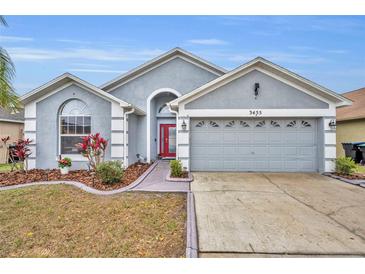 Charming single-story home showcasing a well-manicured lawn and a spacious two-car garage at 3455 Bellingham Dr, Orlando, FL 32825