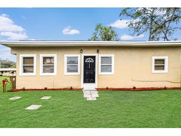 Charming single-story home with a well-maintained lawn and welcoming front entrance at 1622 Dolphin Dr, St Cloud, FL 34771