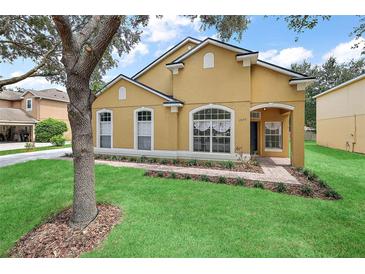 Charming home with a well-manicured lawn and a beautiful mature tree in the front yard at 2073 Home Again Rd, Apopka, FL 32712