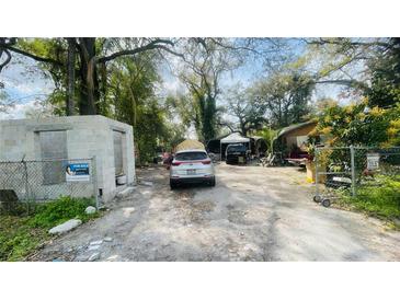 View of the cluttered front yard with multiple vehicles parked on the property at 2516 Cannon St, Lakeland, FL 33815