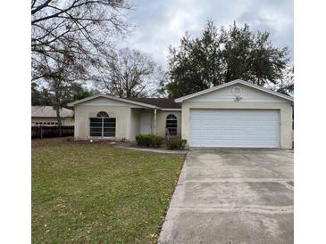 Inviting single Gathering home featuring an attached two-car garage and traditional style windows at 2955 Banyan Ln, Lakeland, FL 33805