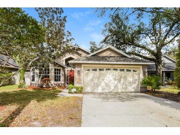 Charming single-Gathering home with a well-maintained lawn and a two-car garage at 1019 Royal Oaks Dr, Apopka, FL 32703