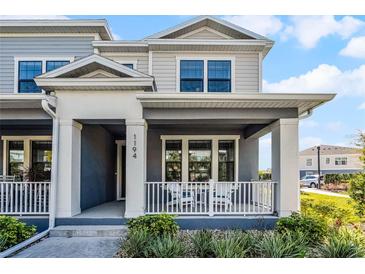 Inviting townhome with covered front porch and white railing, perfect for relaxing outdoors at 1194 Spotted Sandpiper Loop, Winter Springs, FL 32708