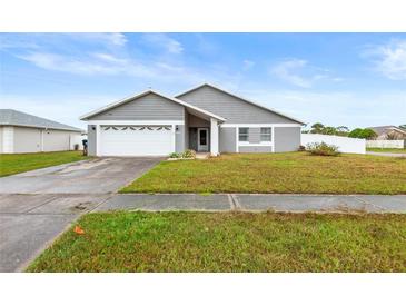 Charming single-story home with well-maintained lawn, driveway and garage at 12853 Maryland Woods Ct, Orlando, FL 32824
