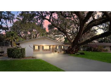 Charming single story home featuring a lovely front yard, spacious driveway and mature landscaping at 3407 Pershing Ave, Orlando, FL 32812