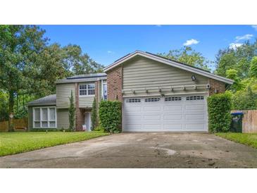 Charming two-story home with a well-maintained lawn and a two-car garage at 5646 Spring Run Ave, Orlando, FL 32819
