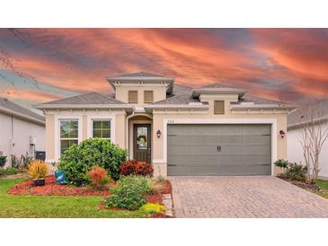 Charming single-Gathering home featuring a well-manicured lawn, a two-car garage, and a welcoming front entrance at 2212 Antilles Club Dr, Kissimmee, FL 34747