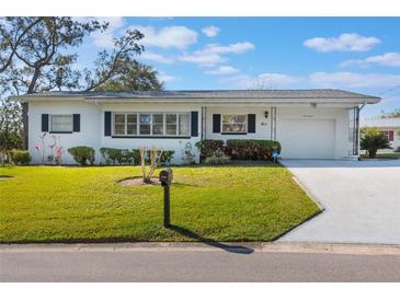 Charming single-story home with a manicured lawn, dark shutters, and an attached one-car garage at 29 Jasmine Dr, Debary, FL 32713