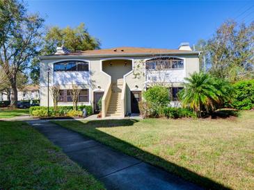 Inviting two-story townhouse with well-maintained landscaping and a bright, open walkway at 2956 S S Semoran Blvd # 1407, Orlando, FL 32822