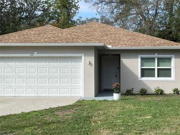 Charming single Gathering home with a well maintained lawn, an attached garage and a neutral colored exterior at 424 Crabtree Ave, Orlando, FL 32835