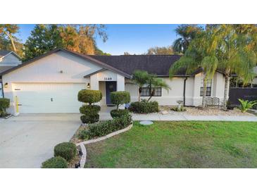 Charming one-story home featuring well-manicured landscaping and an attached two-car garage at 1149 Doyle Rd, Deltona, FL 32725