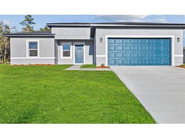 Charming single-Gathering home with a well-manicured lawn and a stylish blue garage door at 15354 Sw 43Rd Avenue Rd, Ocala, FL 34473