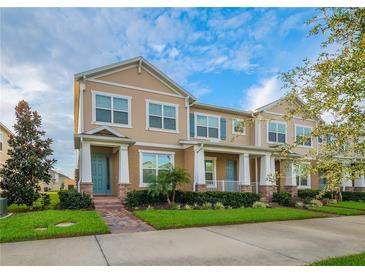 Attractive two-story townhome featuring a welcoming entrance and well-maintained landscaping at 15570 Murcott Blossom Blvd, Winter Garden, FL 34787