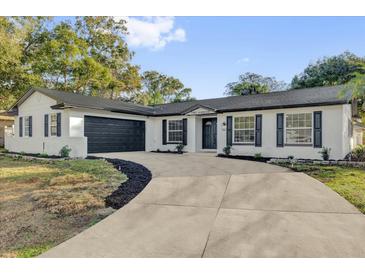 Charming single-story home featuring a well-manicured lawn, a concrete driveway, and an attached two-car garage at 200 Tollgate Trl, Longwood, FL 32750