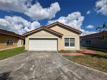 Charming single-story home featuring a tile roof and an attached two-car garage at 235 Tuscany Pointe Ave, Orlando, FL 32807