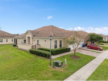 Beautiful single-story home featuring a tile roof, manicured lawn, and paved driveway at 2400 Harwich Dr, Kissimmee, FL 34741