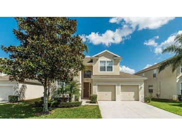 Charming two-story home featuring a well-manicured lawn and a spacious two-car garage at 2683 Manesty Ln, Kissimmee, FL 34747