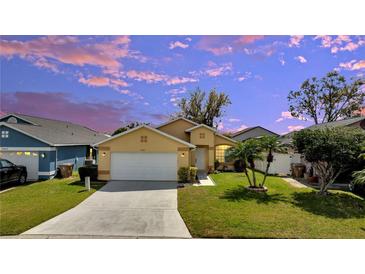 Charming single-story home with a well-manicured lawn, a two-car garage, and a beautifully landscaped front yard at 3084 Stillwater Dr, Kissimmee, FL 34743