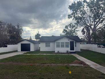 Charming home featuring a freshly painted exterior, detached garage and newly installed white vinyl fence at 636 Coke Ave, Winter Garden, FL 34787