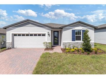 Charming single-story home with a two-car garage and a well-manicured front yard at 792 Griffon Ave, Lake Alfred, FL 33850