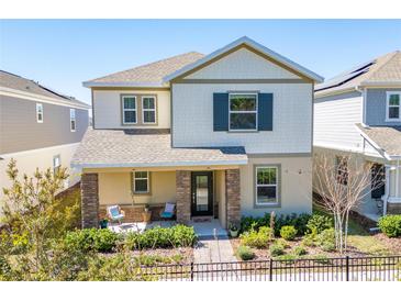 Charming two-story home with a covered front porch, neat landscaping, and stone pillars at 2977 Howley Aly, St Cloud, FL 34771