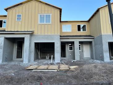 New two-story townhome featuring a garage and covered entryway; construction in progress at 4307 Campsite Loop, Orlando, FL 32824