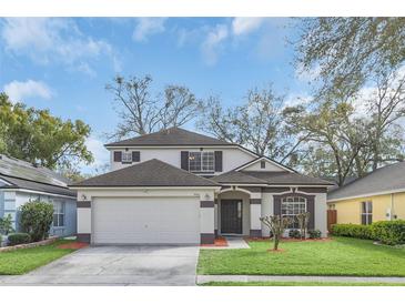 Charming two-story home with a well-manicured lawn, a two car garage, and classic architectural detailing at 5021 Sweet Leaf Ct, Altamonte Springs, FL 32714