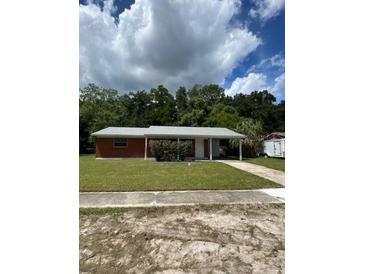 Charming single story home with brick facade, well-maintained lawn, and covered carport at 510 Lavon Dr, Altamonte Springs, FL 32701