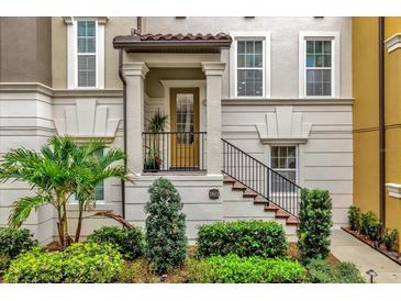Inviting front entrance featuring a classic design, well-maintained landscaping, and decorative wrought iron railing at 1012 Parma Cir, Lake Mary, FL 32746