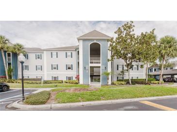 Condominium exterior featuring a blue and white color scheme and well-maintained landscaping at 1109 Clubside Dr # 1109, Longwood, FL 32779