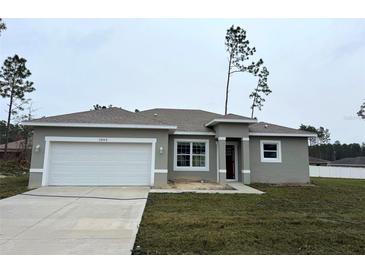 Charming one-story home featuring a two-car garage, neutral paint, and well-manicured lawn at 13163 Sw 70Th Ct, Ocala, FL 34473