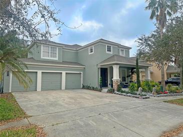 Charming two-story home with a three-car garage and beautifully landscaped front yard at 13413 Hopkinton Ct, Windermere, FL 34786