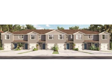 Inviting townhouse exterior featuring a neat facade, individual driveways, and lush landscaping at 2171 Longleaf Rd, Davenport, FL 33837