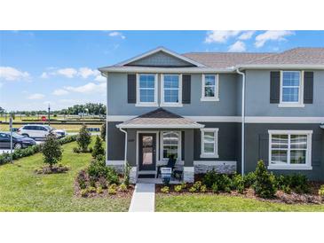 Charming two-story home with a well-manicured lawn and welcoming front porch at 2688 Gouda Dr, Apopka, FL 32703