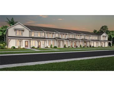 New construction townhomes featuring craftsman-style architecture, covered entries, and lush landscaping at 6424 Tabebuia Pkwy, Winter Garden, FL 34787