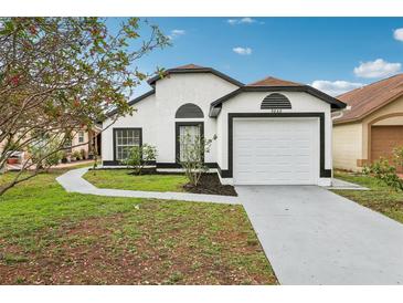 Charming single-Gathering home with a well-maintained lawn and attached two-car garage at 9868 Flynt Cir, Orlando, FL 32825