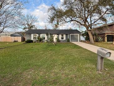 Charming single-story home with mature trees and a well-maintained lawn at 1067 Lyric Dr, Deltona, FL 32738